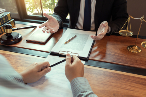 Embry Hills premises liability lawyer, premises liability law, Image of a legal team discussing premises liability lawsuits with a focus on premises liability accidents and the legal duty of property owners to maintain safe environments. 